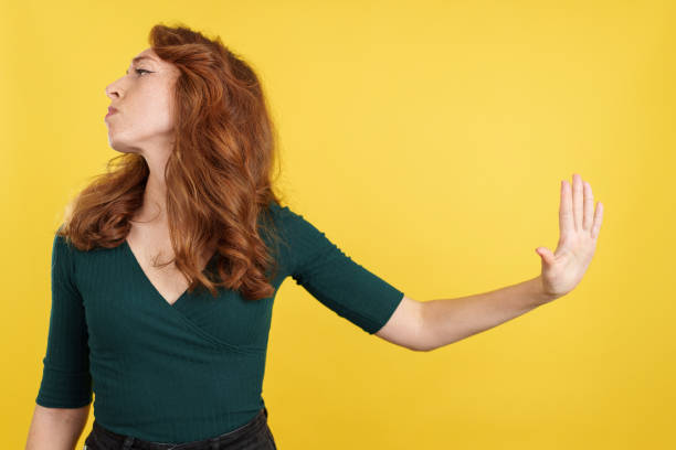 istock Angry redheaded woman reusing to talk gesturing with the hand 1476425717