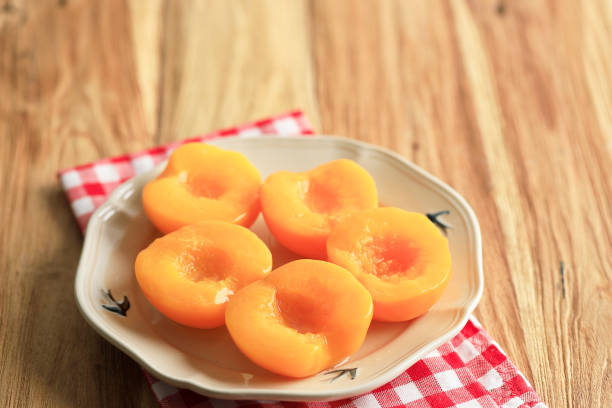 Canned Peach Halves in Ceramic Plate, Wooden Table