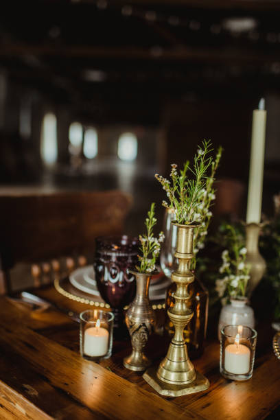 istock Flowers in vases and candles on a rustic dinner table 1476435330