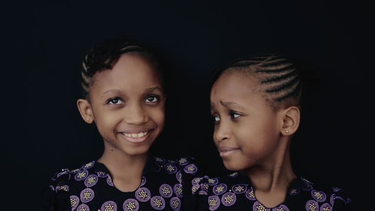 Portrait confident African twin sisters