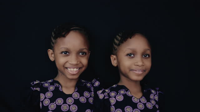 Portrait confident African twin sisters
