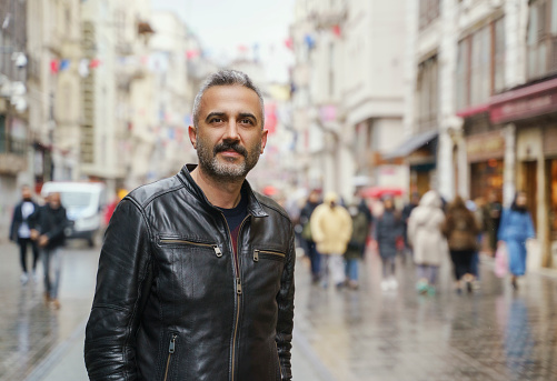 Portrait of a mid adult man standing on the Istiklal Street, Looking at camera