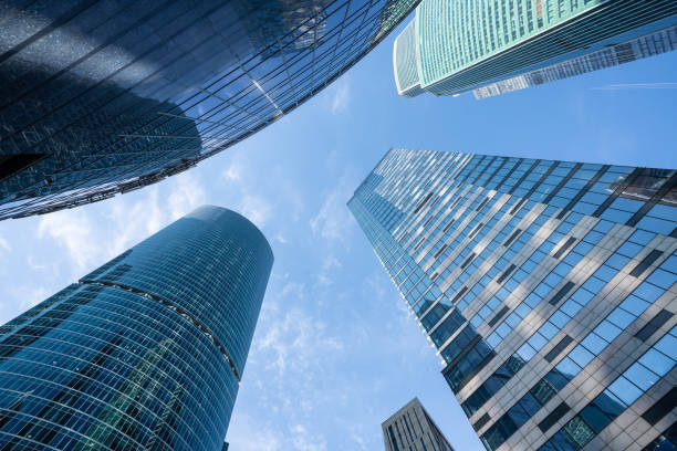 Modern office buildings of downtown at sunny day with clear blue sky, looking up