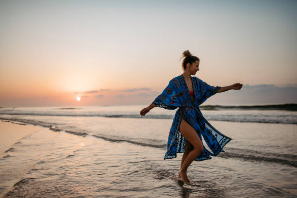 istock Young woman enjoying time at sea, dancing. 1476463969