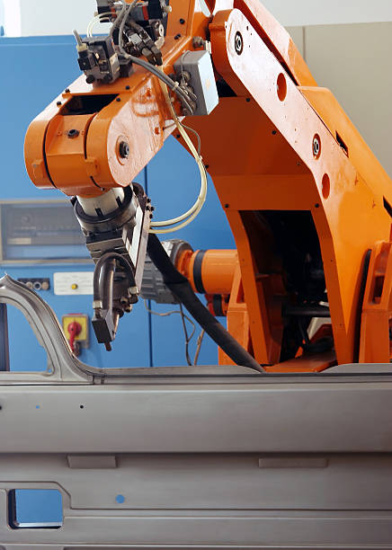 istock An orange electronic robot arm on an assembly line 147646398