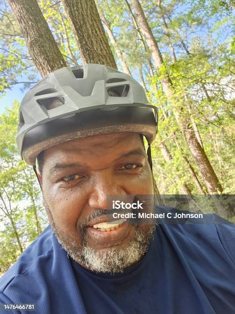 Close Up Middle Age Black Male Exercising Riding Bike Outdoors Stock Photo - Download Image Now