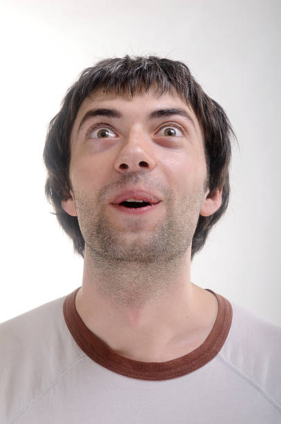 surprised man's face look up stock photo