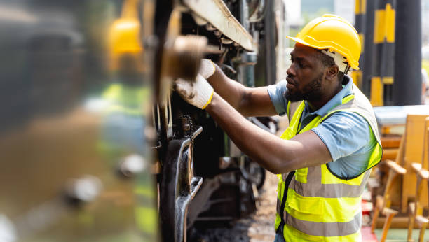 engenheiros profissionais em roupas de trabalho seguras ele está verificando as grandes máquinas com intenção. os trabalhadores estão olhando para partes da máquina e inspecionando com habilidade no conceito de trabalhador industrial. - heavy plant - fotografias e filmes do acervo