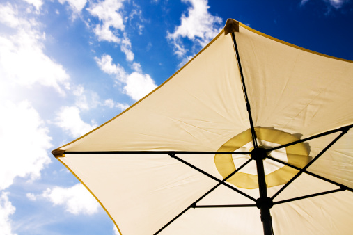 Photograph of a patio Parasol from a low point of view.