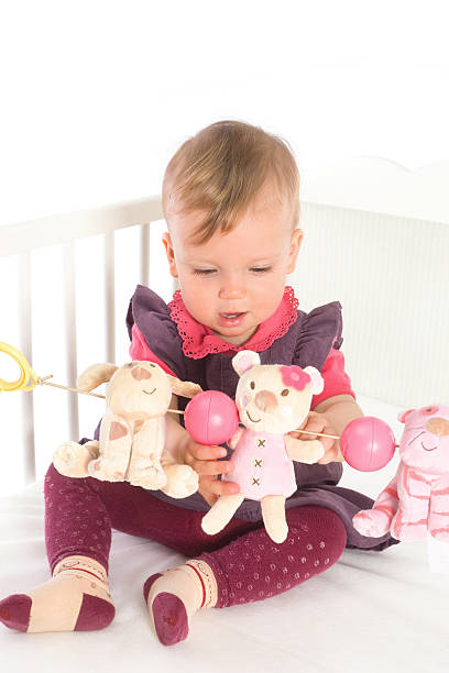 istock Baby Girl playing in bed 147648432