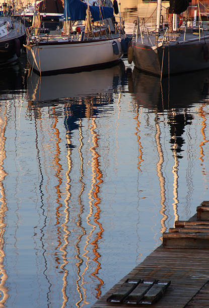 Sailboat masts reflection stock photo