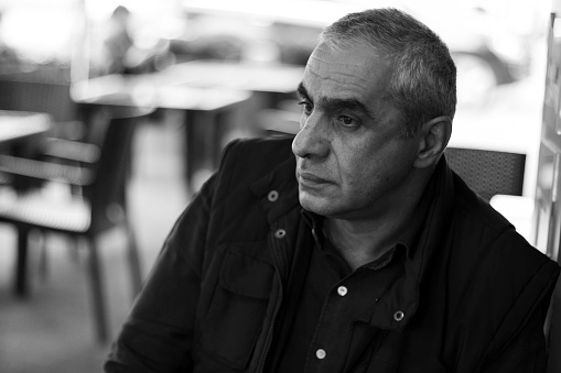 Thoughtful senior man sitting at table