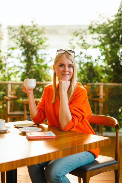 istock Young Woman Drinking Coffee in Cafe 1476496519