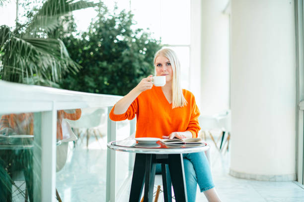 istock Young Woman Drinking Coffee in Cafe 1476496673