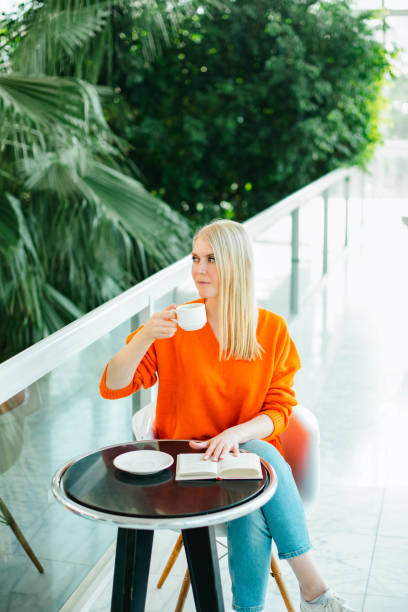 istock Young Woman Drinking Coffee in Cafe 1476496701