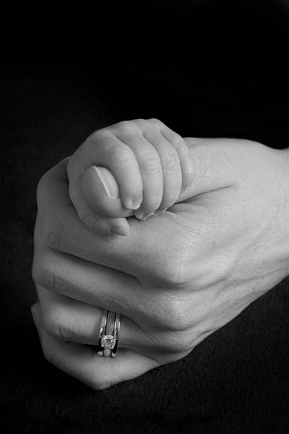istock Baby and Mom Holding Hands 147650036
