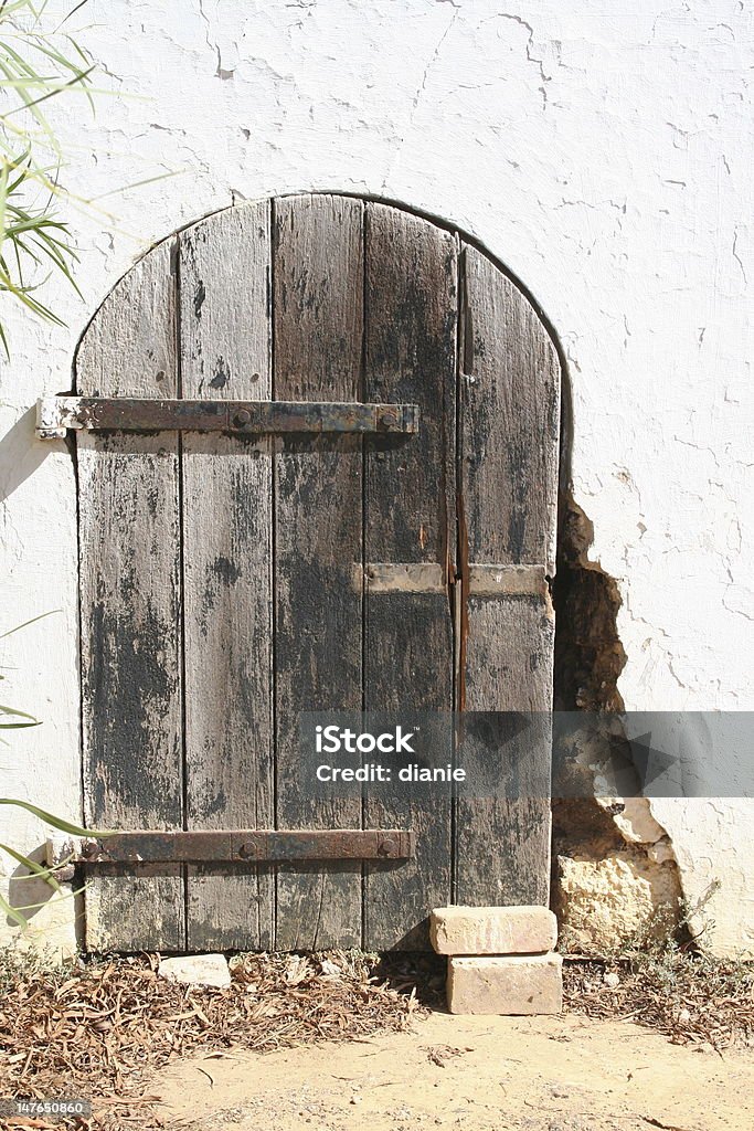 Ruin door An old ruin with an arch door and some of the bricks falling apart Arch - Architectural Feature Stock Photo