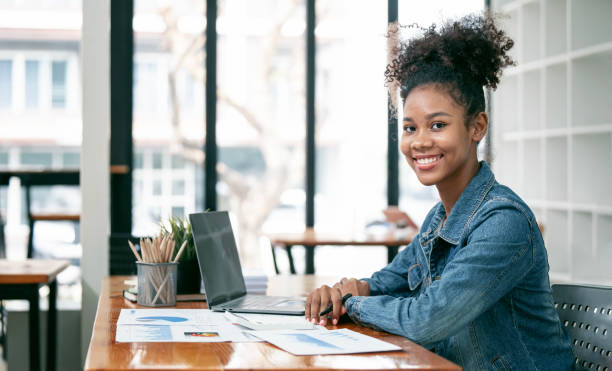 istock Portrait beautiful black woman smiling and using laptop computer, smiling to camera. 1476508607