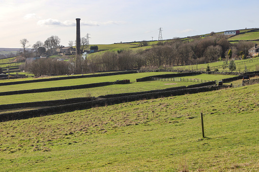 The remains of Providence Mill in Oakworth, Yorkshire. The chimney stack is all that remains of this once bustling textile mill.