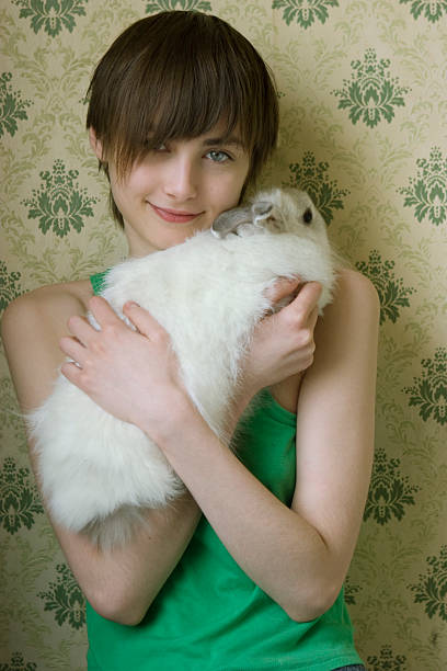 portrait of young woman with rabbit stock photo
