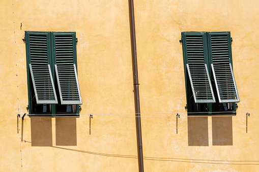 Two Shuttered Windows On A Hot Day Seen In Lucca, Tuscany