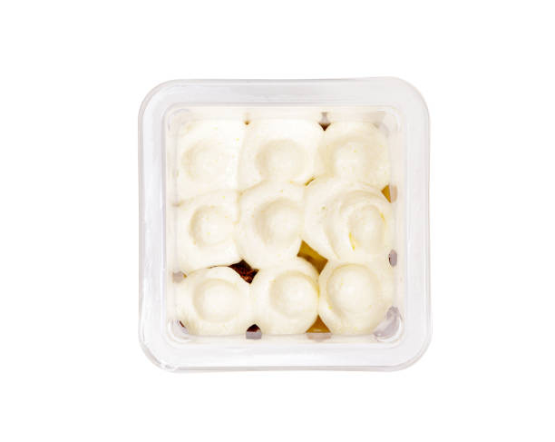 istock Portion of chocolate caramel mousse in a plastic cup on a white background. View from above. 1476513577