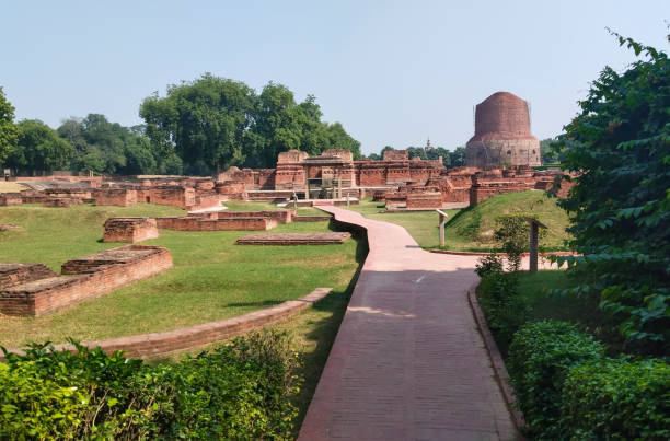 Dhamekh Stupa and ruins in Sarnath, India Dhamekh Stupa and ruins in Sarnath, India sarnath stock pictures, royalty-free photos & images