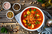 Tomato soup with chickpea on wooden background