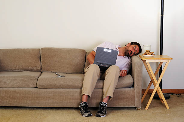 Computer nerd falls asleep auf couch – Foto