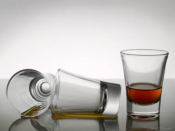 istock Three shot glasses with one partially full 147652590
