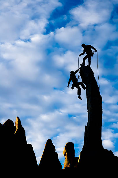 istock Team of climbers reaching the summit. 147652618