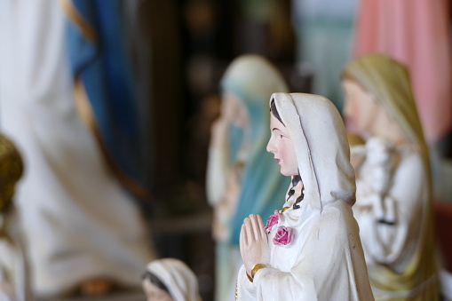 Closeup of the statue of virgin Mary praying