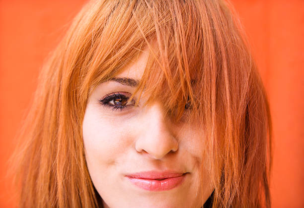 Woman with exasperated expression Young redheaded woman looking at viewer with funny expression. bangs stock pictures, royalty-free photos & images