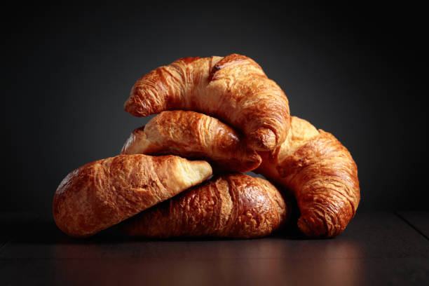 istock Freshly baked croissants on a black ceramic table. 1476537327