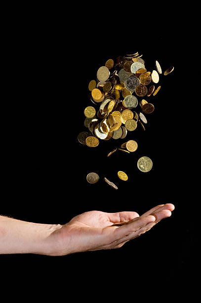 istock Hand throwing gold coins in the air 147655594