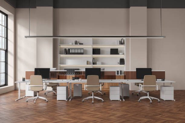 istock Beige office interior with pc computer and shelf near panoramic window 1476562195