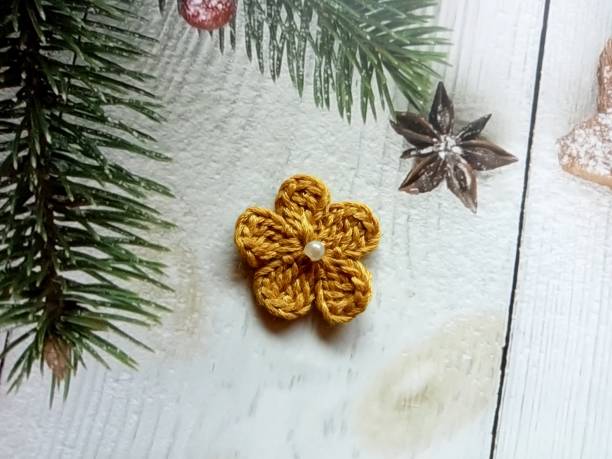 istock Crochet flower gold colour background texture 1476566981