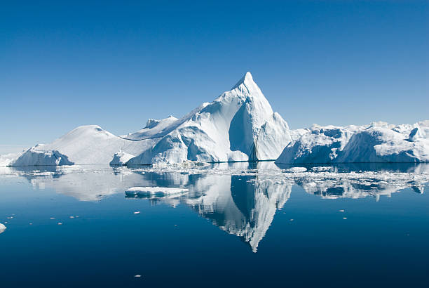 Iceberg Icebergs drift in calm seas off the Greenland coast. polar climate stock pictures, royalty-free photos & images