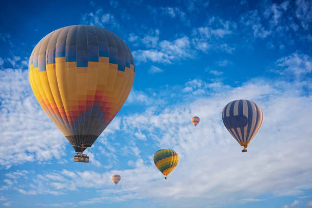 Colorful hot air balloon flying above the clouds
