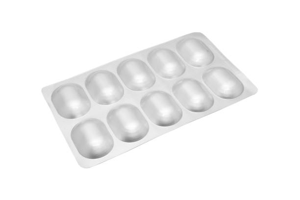 istock Macro shot pile of tablets pill in silver blister packaging isolated on white background. Aluminium foil blister pack. Pharmacy products. Medicine pills and drugs close up. Pills background 1476567778