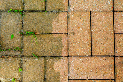 Patio bricks showing the difference made by power washing