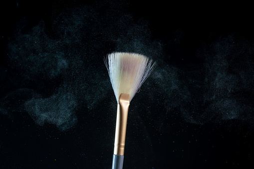 blush brushes with colorful powder crashing