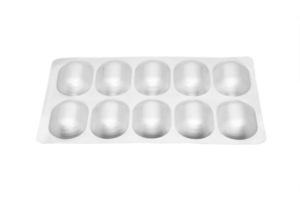 istock Macro shot pile of tablets pill in silver blister packaging isolated on white background. Aluminium foil blister pack. Pharmacy products. Medicine pills and drugs close up. Pills background 1476574082