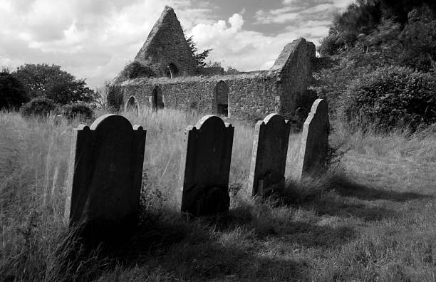 istock Ruined church and four graves. 147657623