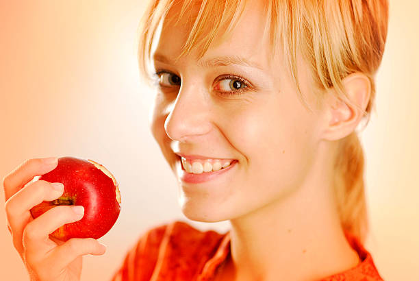 Girl with an apple stock photo