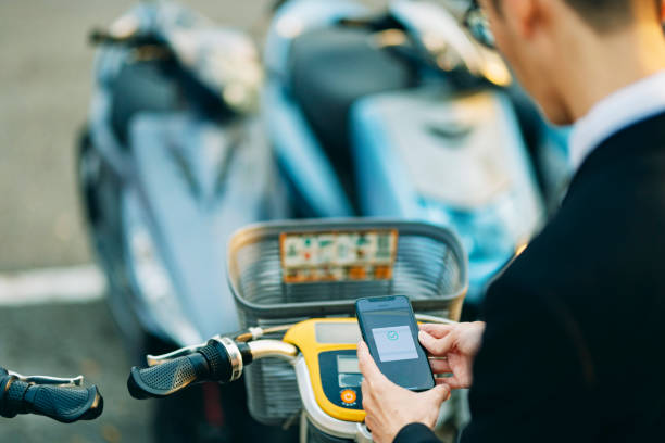 istock An Asian male office worker is using his phone to scan the QR code of a shared bicycle in the city, getting ready to rent and use it. 1476588284
