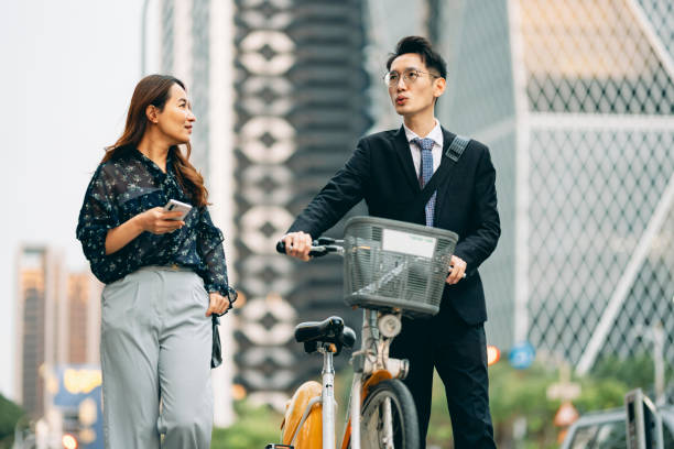 istock Two Asian business people met while commuting and discussed their work projects together. 1476589182