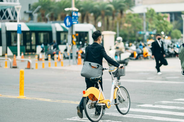 istock A business Asian man is riding a bicycle on his commute to or from work. 1476589190