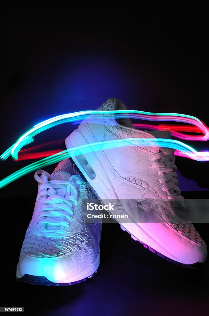 Sneakers Light painting over the sneakers on black background Activity Stock Photo
