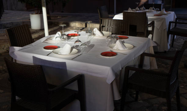 istock Table set up at sunset for an open-air dinner 1476595654